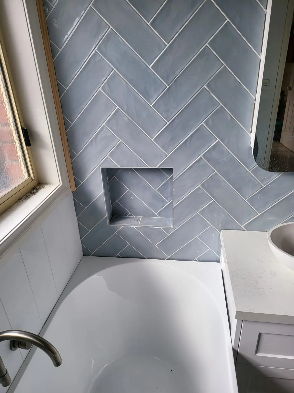 Herringbone tile detail with built-in niche