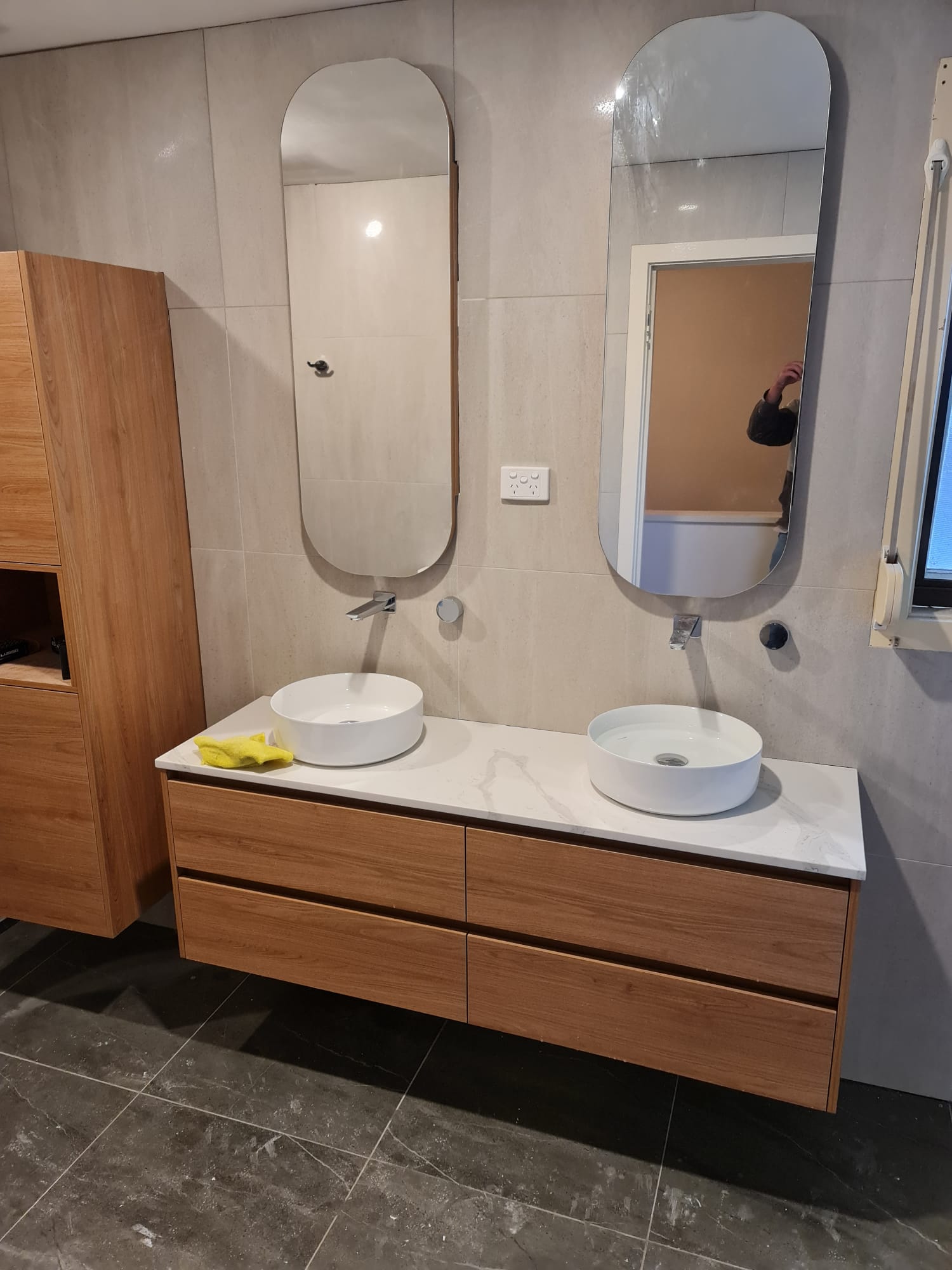 Double floating vanity close-up with twin vessel basins and stone benchtop