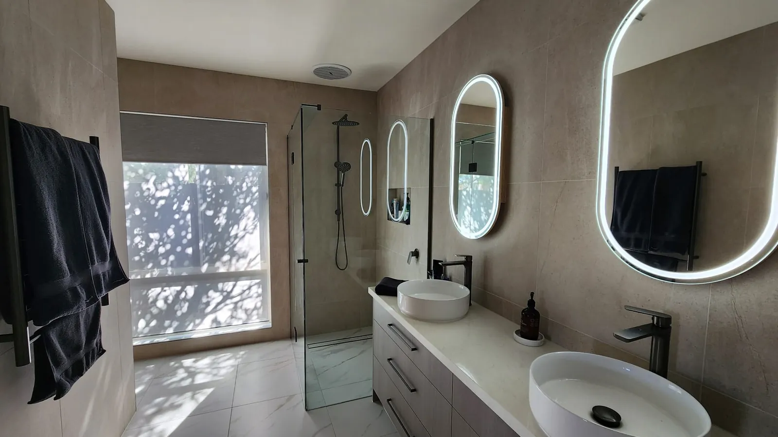 Armstrong Creek bathroom renovation with limestone-look tiles, double floating vanity and matte black fittings