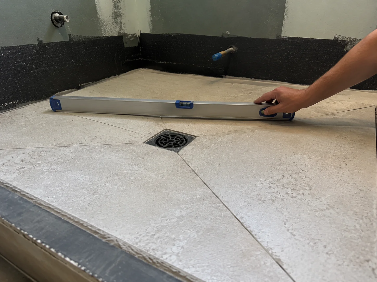 Bathroom floor graded to fall toward the drain as required under AS 3740 in a Geelong renovation
