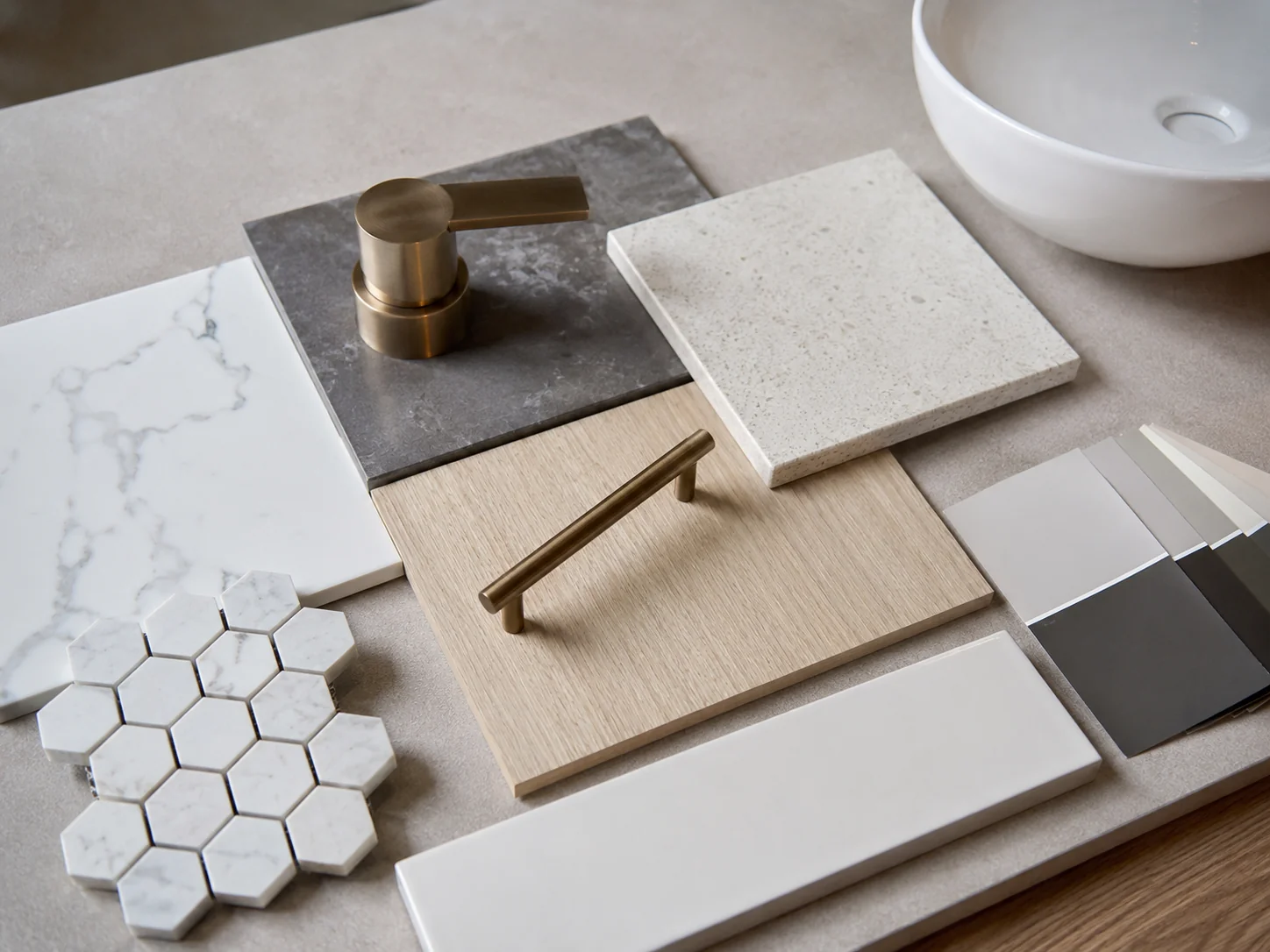 Tile, tapware and fixture samples laid out for a Geelong bathroom renovation selection
