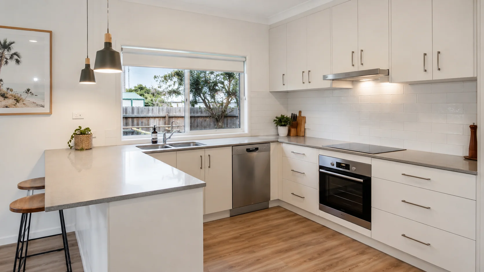 Mid-range kitchen renovation in Geelong with semi-custom cabinetry, engineered stone benchtop and integrated appliances