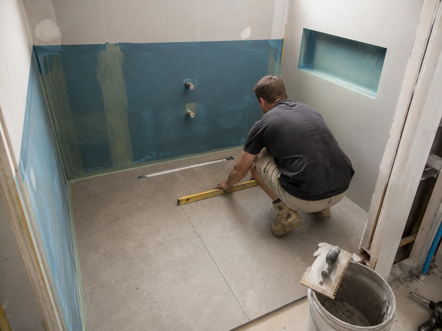 Waterproofing membrane and fall to floor drain being installed for a walk-in shower in Geelong