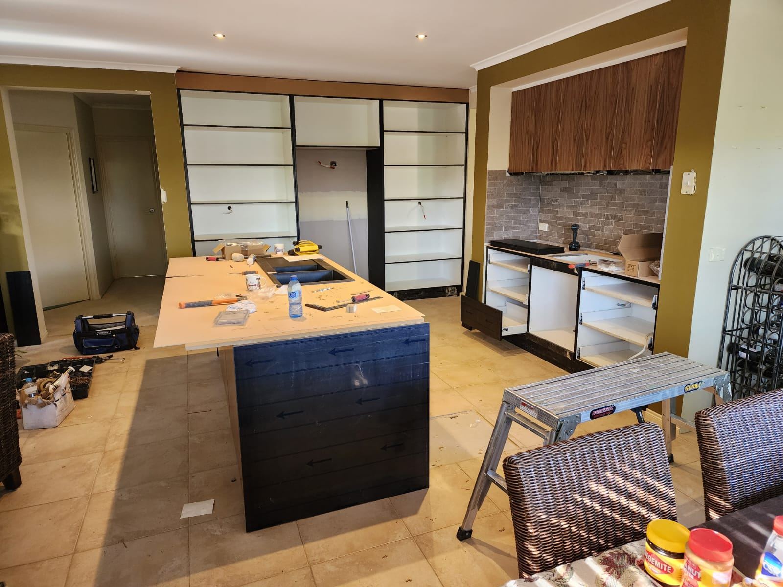 Kitchen island and shelving unit during installation