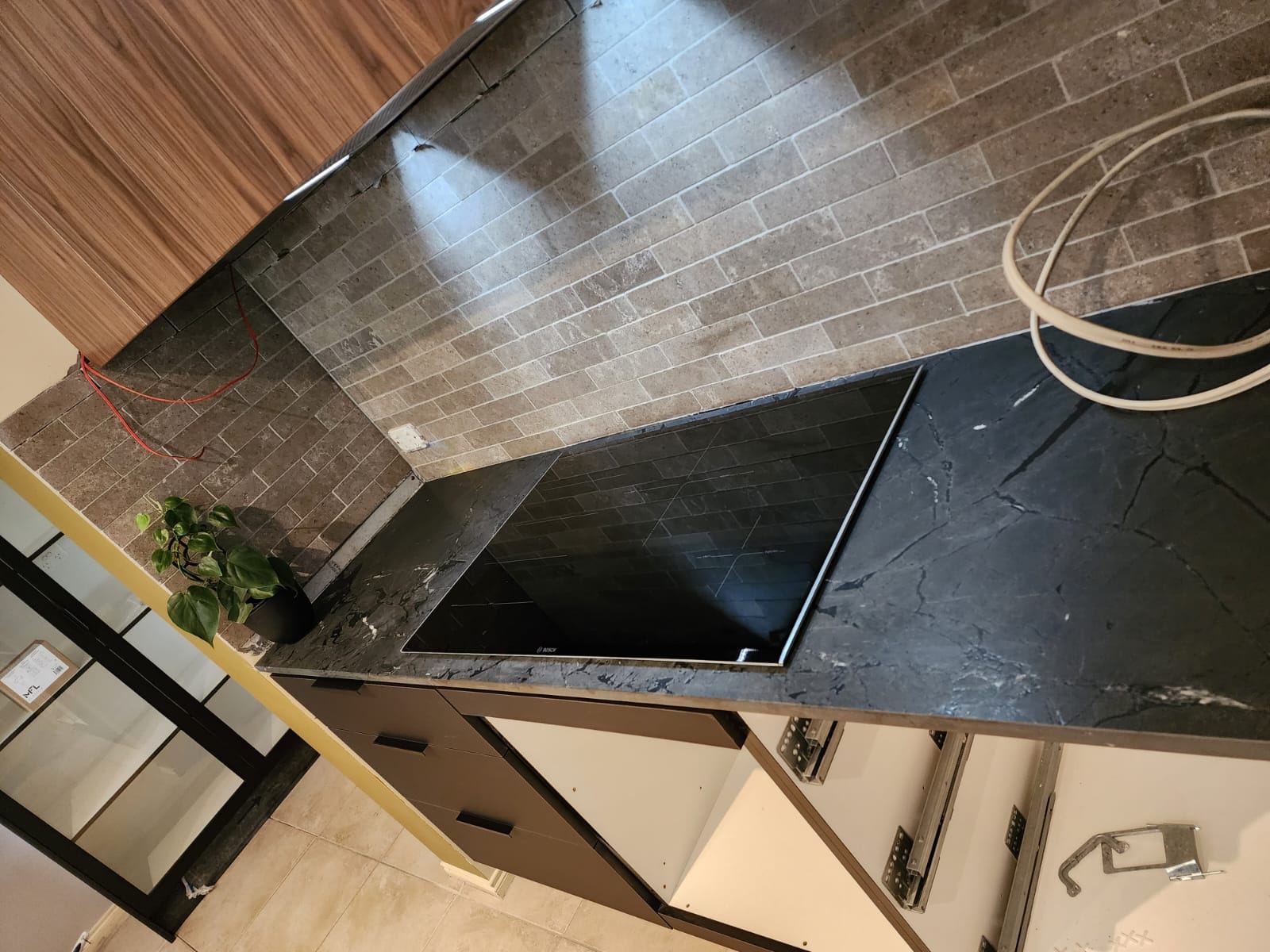 Splashback tile and induction cooktop detail