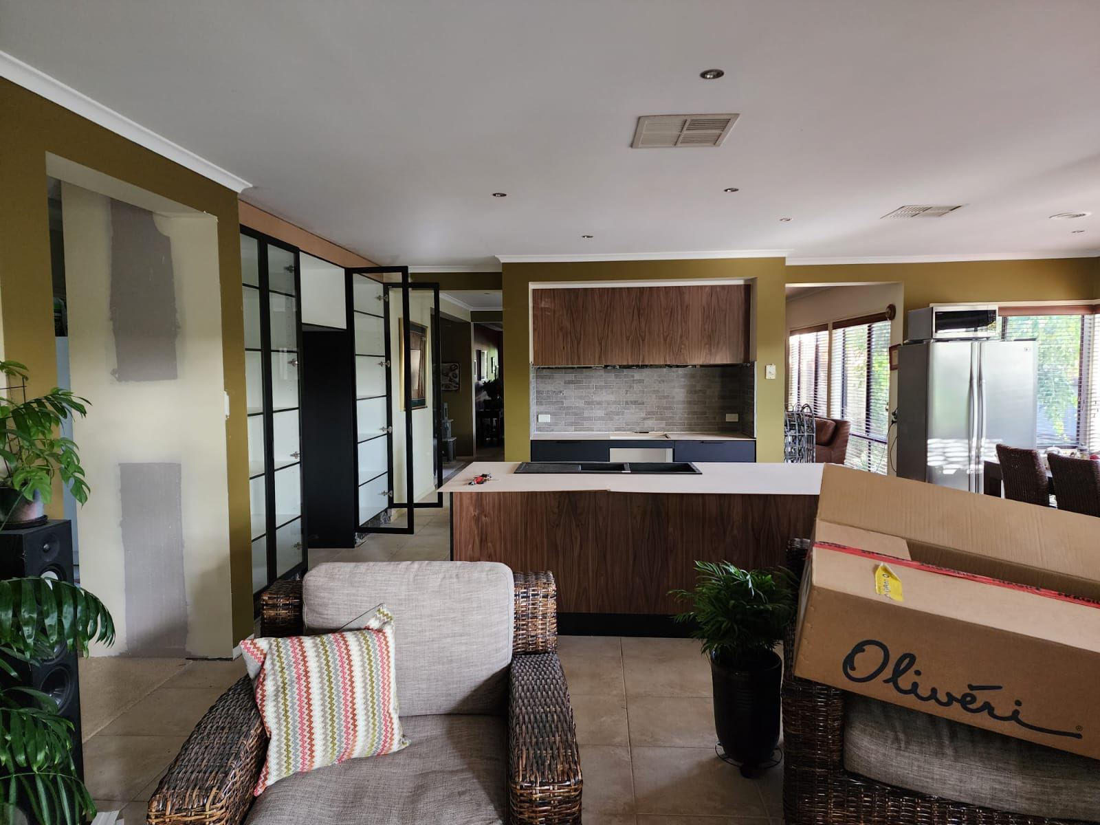 Wide shot of finished kitchen with display unit and cabinetry