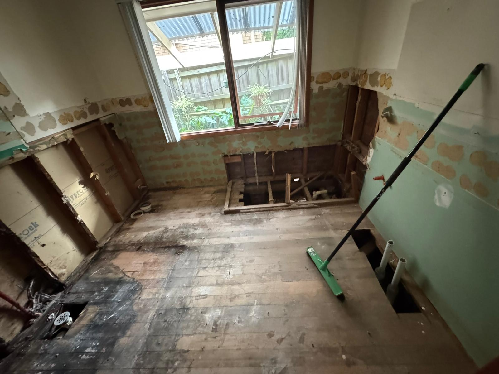 Bathroom stripped back to timber floorboards and framing during demolition